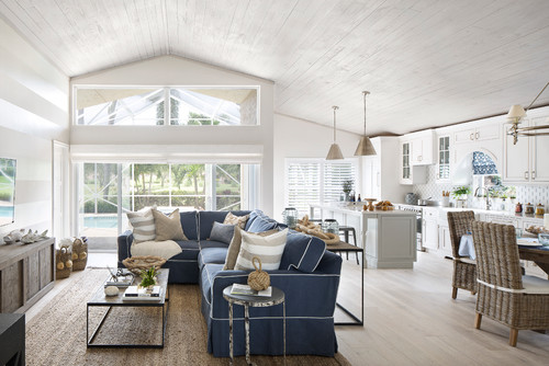 beach style living room in Miami featuring white walls and blue sofa