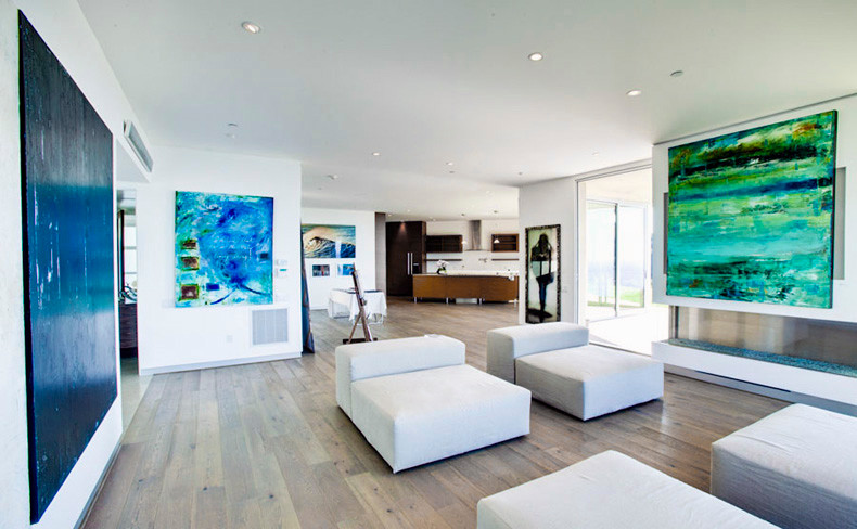 Inspiration for a large modern enclosed games room in Los Angeles with white walls and medium hardwood flooring.