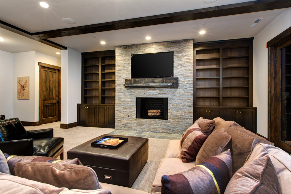 Huge mountain style enclosed carpeted game room photo in Salt Lake City with white walls, a standard fireplace, a tile fireplace and a wall-mounted tv