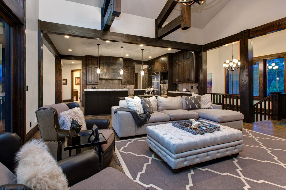Inspiration for an expansive rustic open plan games room in Salt Lake City with white walls, carpet, a standard fireplace, a stone fireplace surround and a wall mounted tv.