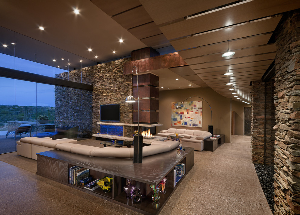 Southwest family room photo in Phoenix with beige walls and a wall-mounted tv