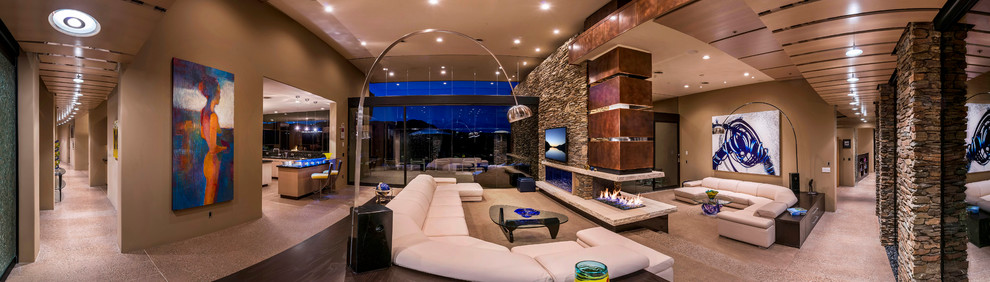 Example of a large trendy open concept concrete floor family room design in Phoenix with beige walls and a wall-mounted tv