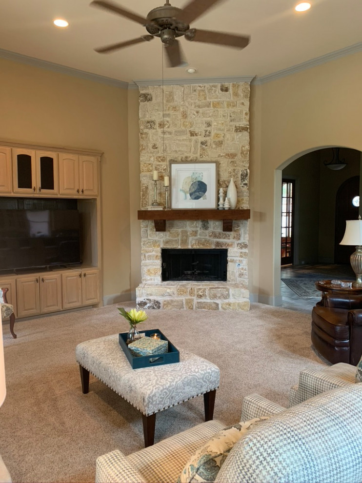 Inspiration for a medium sized traditional open plan games room in Dallas with beige walls, carpet, a corner fireplace, a stone fireplace surround, a built-in media unit and beige floors.