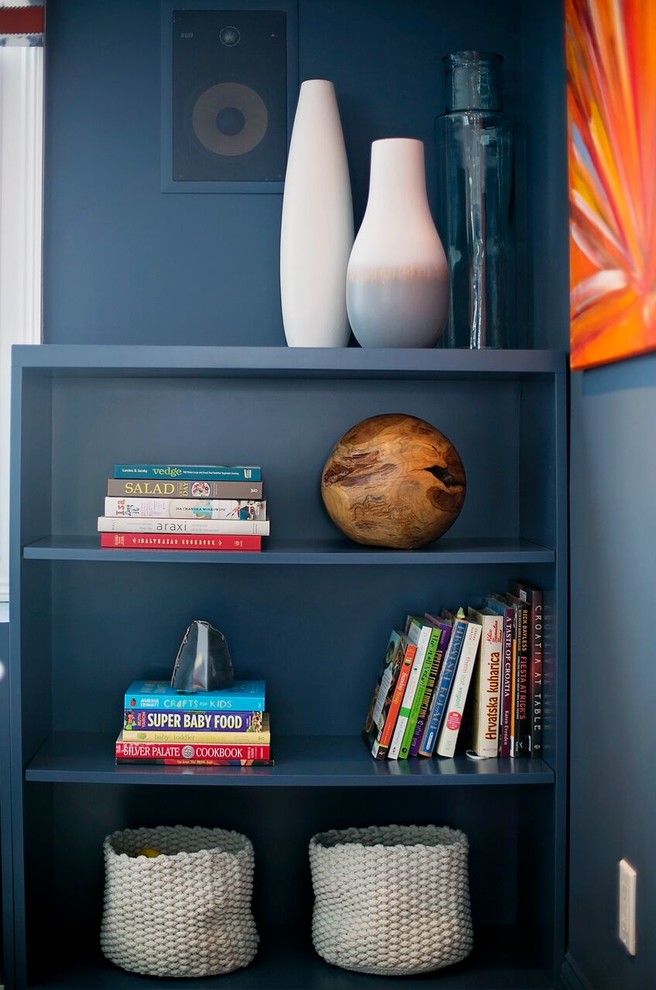 Mid-sized minimalist enclosed carpeted family room photo in New York with blue walls, a standard fireplace, a stone fireplace and a wall-mounted tv