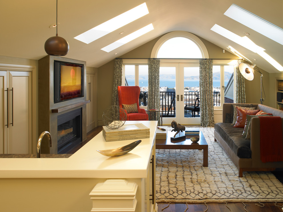 Photo of a classic mezzanine games room in San Francisco with beige walls, dark hardwood flooring, a standard fireplace, a concrete fireplace surround and a wall mounted tv.