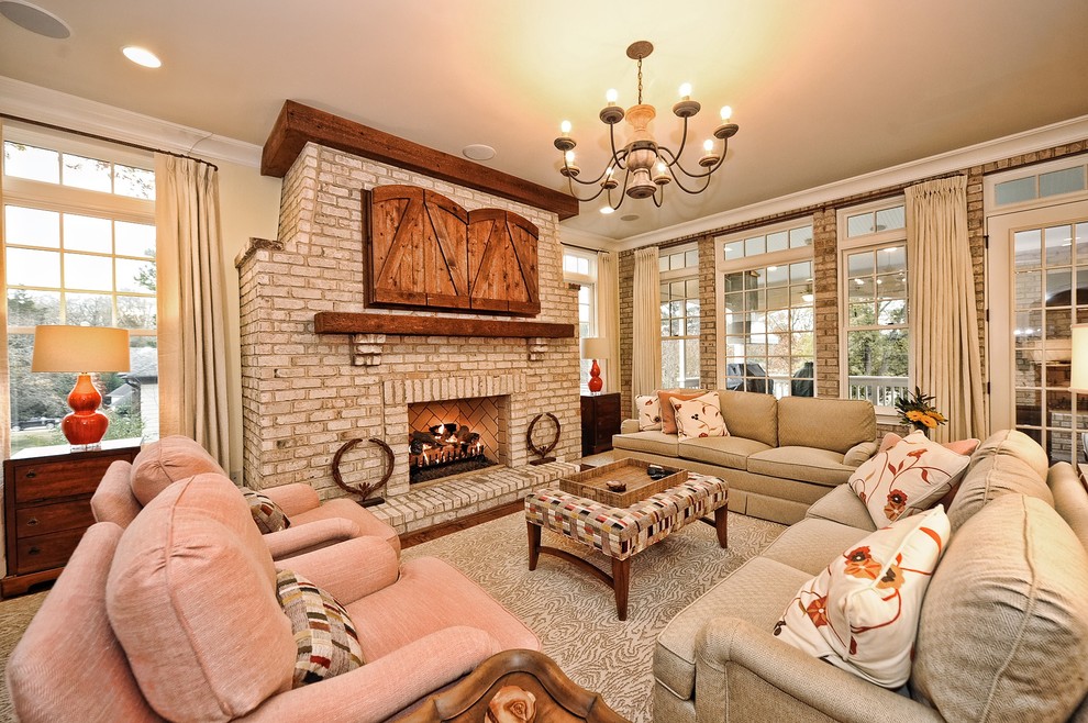 Design ideas for a large classic open plan games room in Charlotte with medium hardwood flooring, a standard fireplace, a brick fireplace surround, a concealed tv and beige walls.