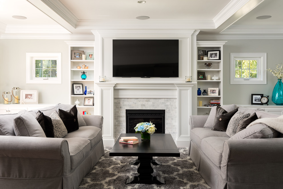 Family room - mid-sized traditional enclosed dark wood floor family room idea in Boston with gray walls, a standard fireplace, a tile fireplace and a wall-mounted tv