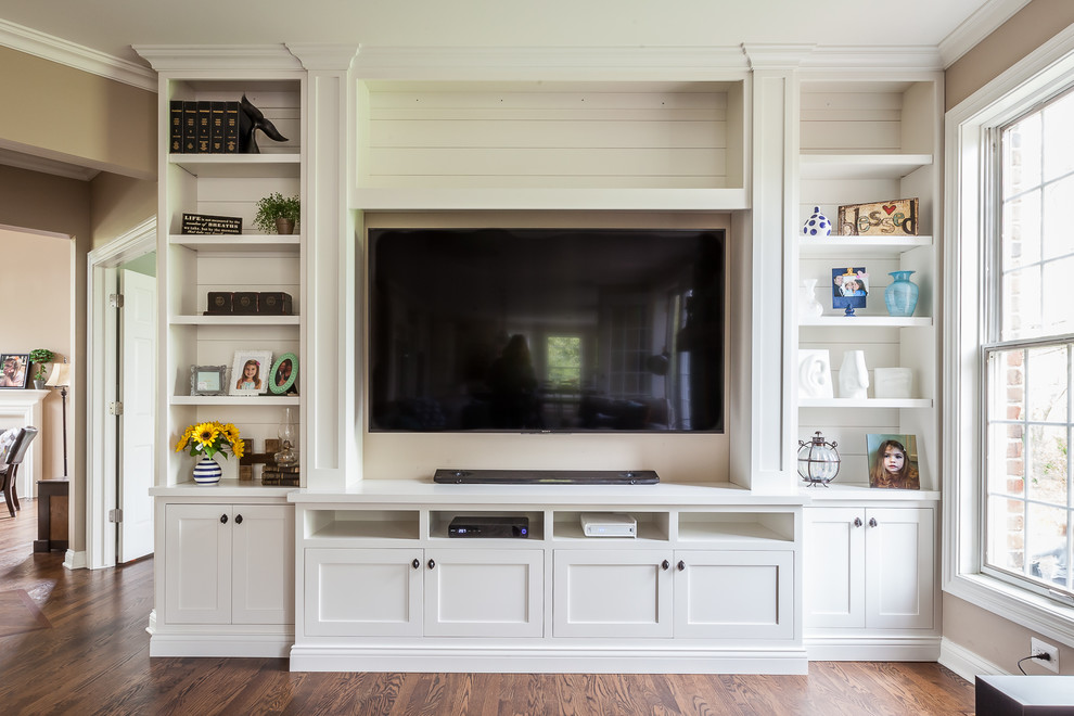 This is an example of a large farmhouse games room in Chicago with white walls, medium hardwood flooring and a built-in media unit.
