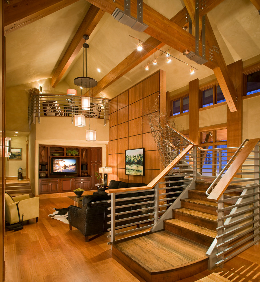 Large rustic open plan games room in Other with beige walls, light hardwood flooring, no fireplace, a built-in media unit and brown floors.