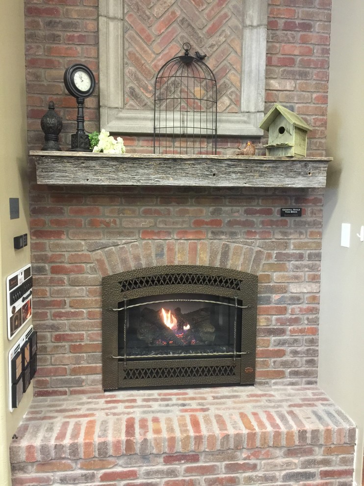 Photo of a medium sized traditional games room in Denver with a standard fireplace and a brick fireplace surround.