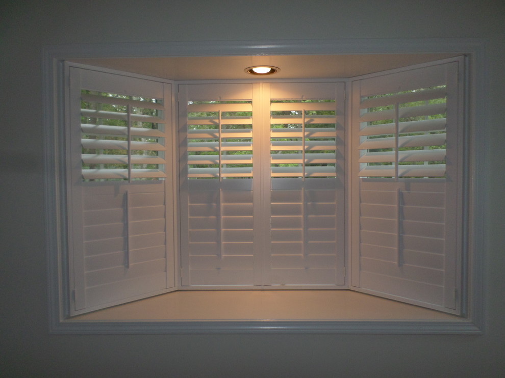 This is an example of a medium sized coastal games room in Boston with white walls and medium hardwood flooring.