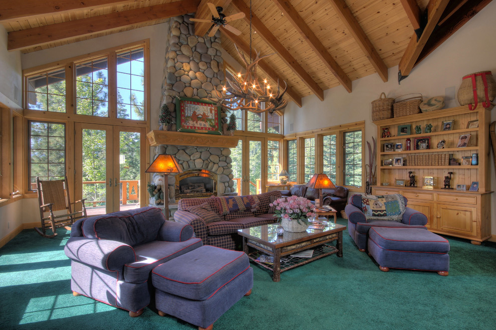 Example of a large mountain style open concept carpeted family room design in Sacramento with beige walls, a standard fireplace and a stone fireplace