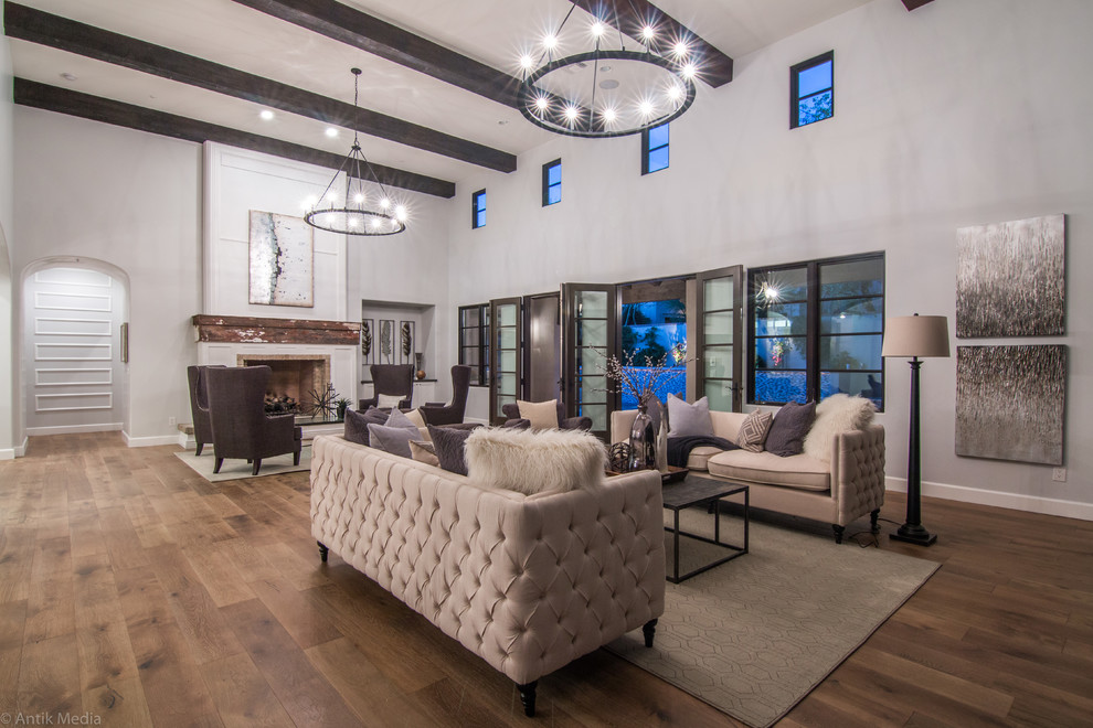 This is an example of a large traditional open plan games room in Phoenix with grey walls, painted wood flooring, a standard fireplace, no tv and brown floors.