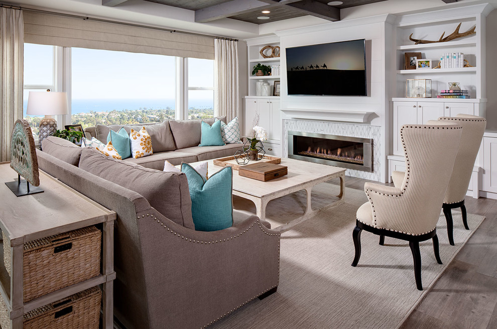 Design ideas for a large coastal open plan living room in San Diego with a wall mounted tv, beige walls, a ribbon fireplace, a tiled fireplace surround and light hardwood flooring.