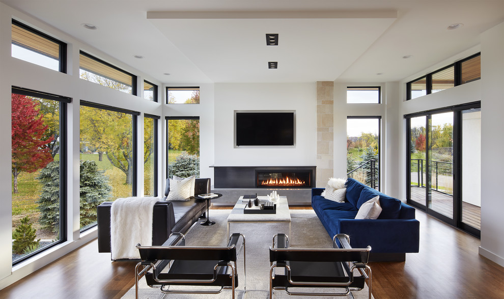 Minimalist open concept dark wood floor family room photo in Minneapolis with white walls, a ribbon fireplace and a wall-mounted tv
