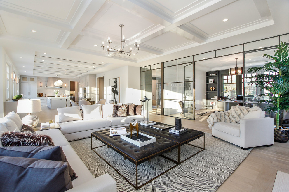Example of a large trendy open concept light wood floor and beige floor family room design in New York with white walls, a standard fireplace and a stone fireplace