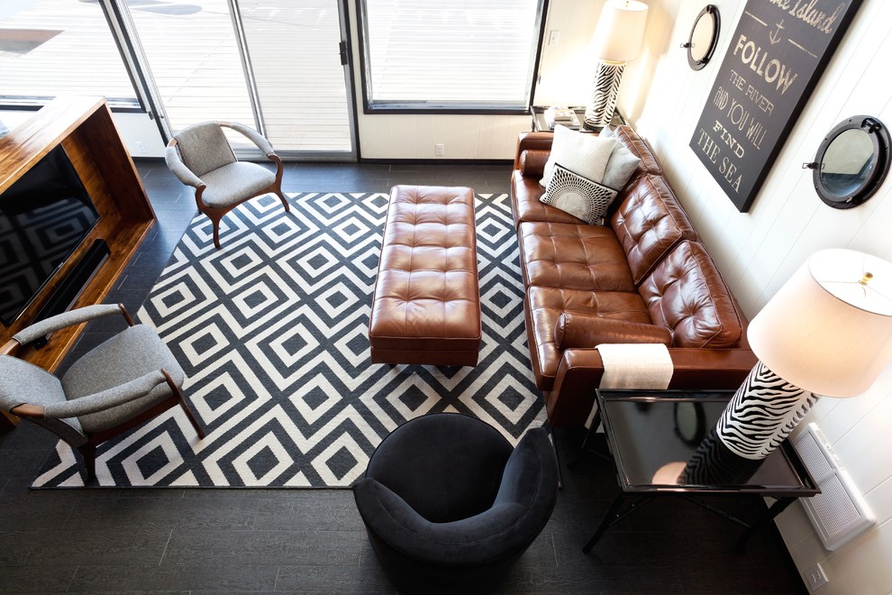 Mid-sized eclectic open concept black floor and laminate floor family room photo in Portland with white walls, no fireplace and a wall-mounted tv