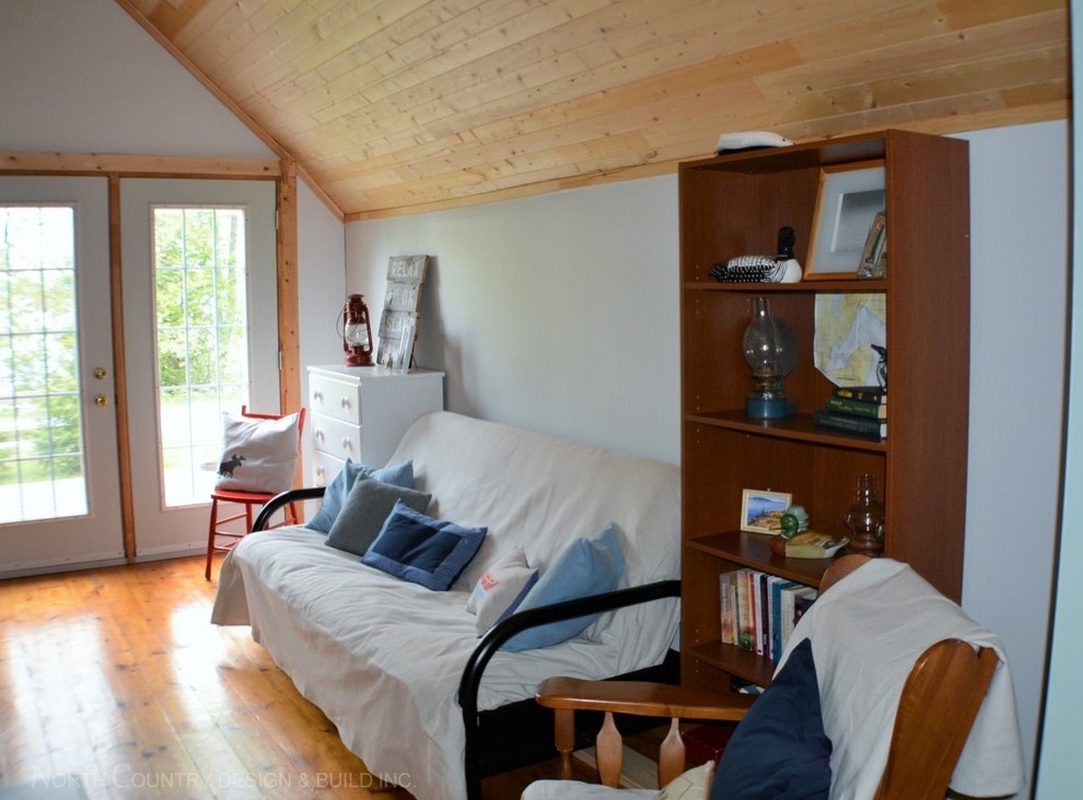 Ejemplo de sala de estar abierta rural pequeña con paredes grises y suelo de madera en tonos medios