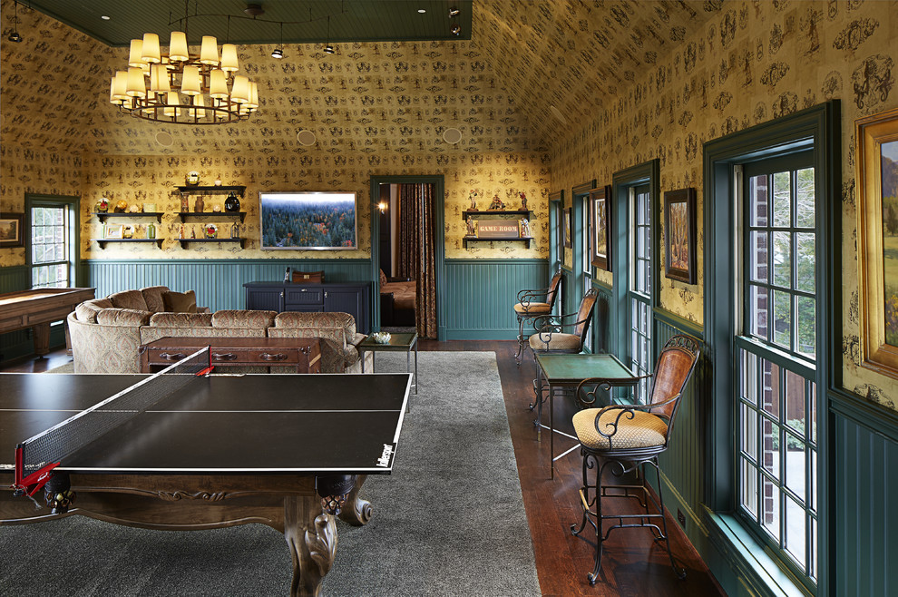 This is an example of an expansive traditional enclosed games room in Dallas with multi-coloured walls, dark hardwood flooring, a wall mounted tv, no fireplace, brown floors and a dado rail.