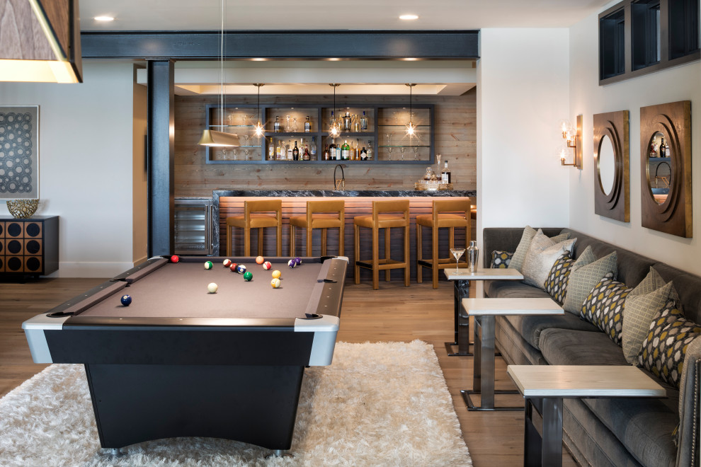 This is an example of a large contemporary open plan games room in Minneapolis with white walls, medium hardwood flooring, brown floors and no tv.
