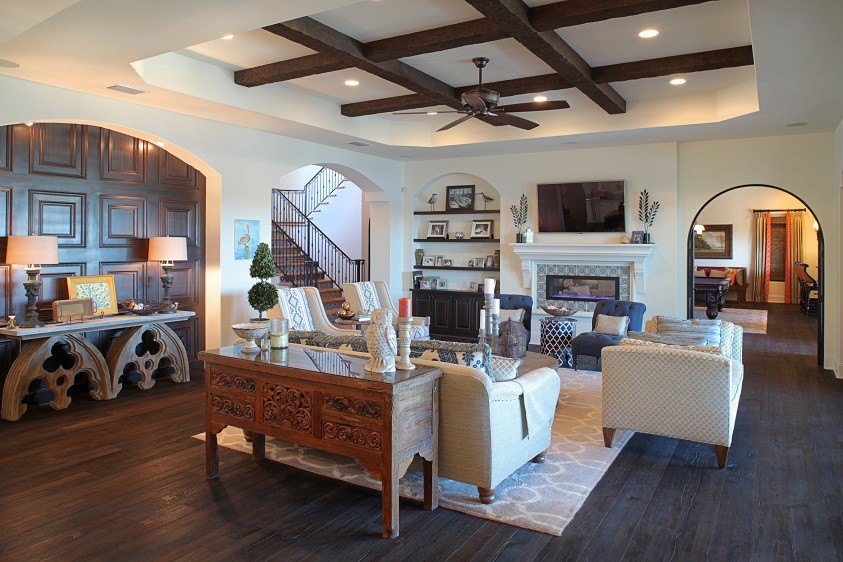 Inspiration for a large mediterranean open plan games room in Tampa with white walls, dark hardwood flooring, a two-sided fireplace, a tiled fireplace surround and a wall mounted tv.
