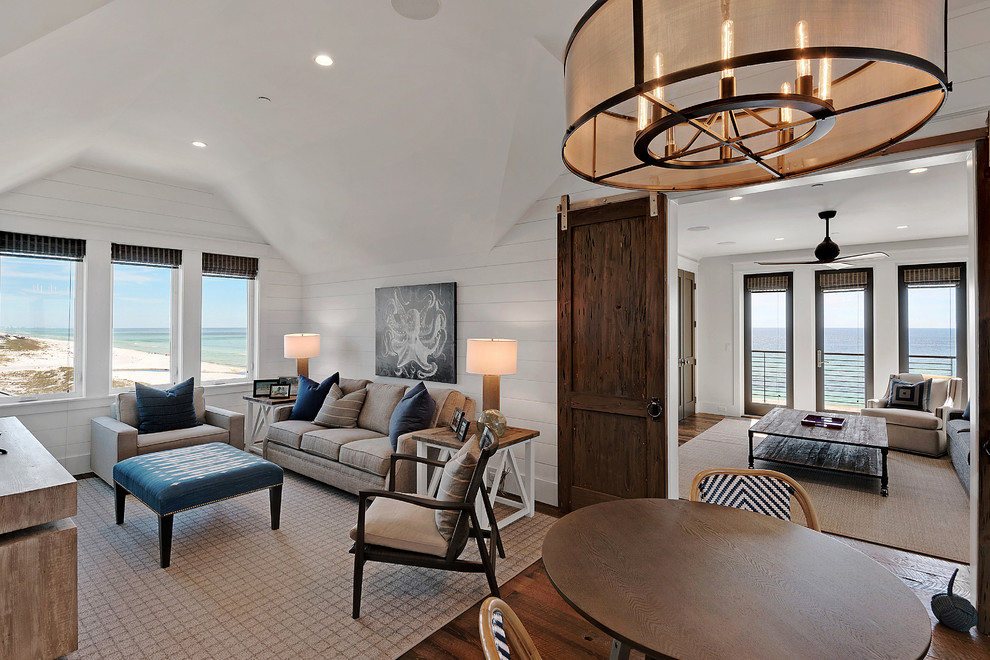 This is an example of a coastal games room in Miami with white walls and dark hardwood flooring.