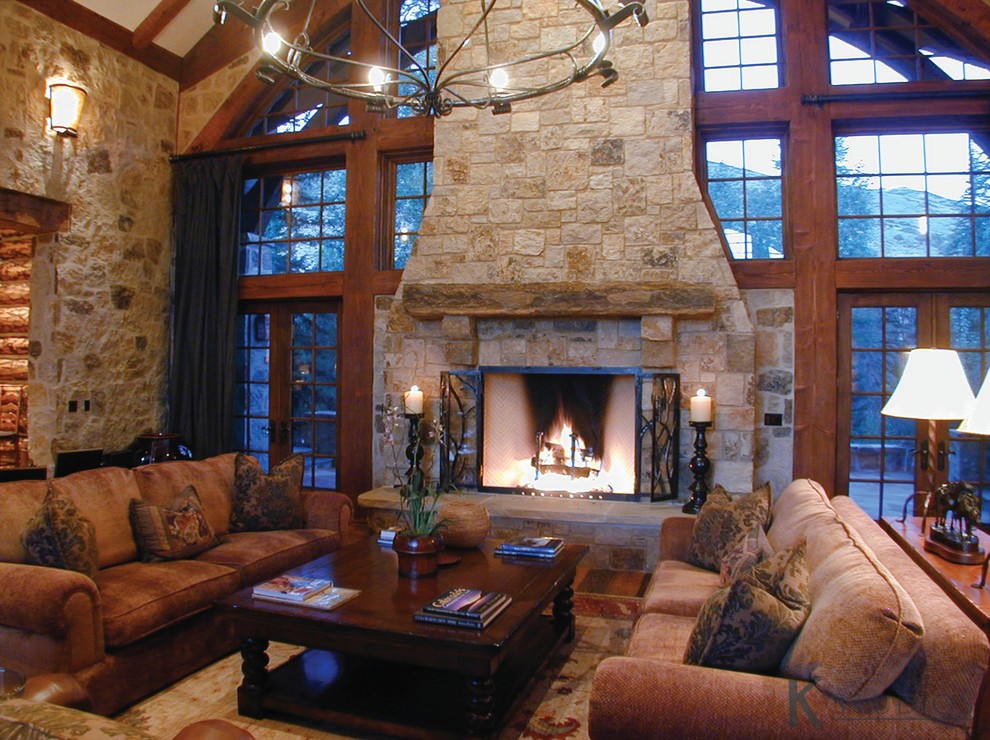 Example of a huge mountain style open concept medium tone wood floor family room design in Denver with a standard fireplace and a stone fireplace