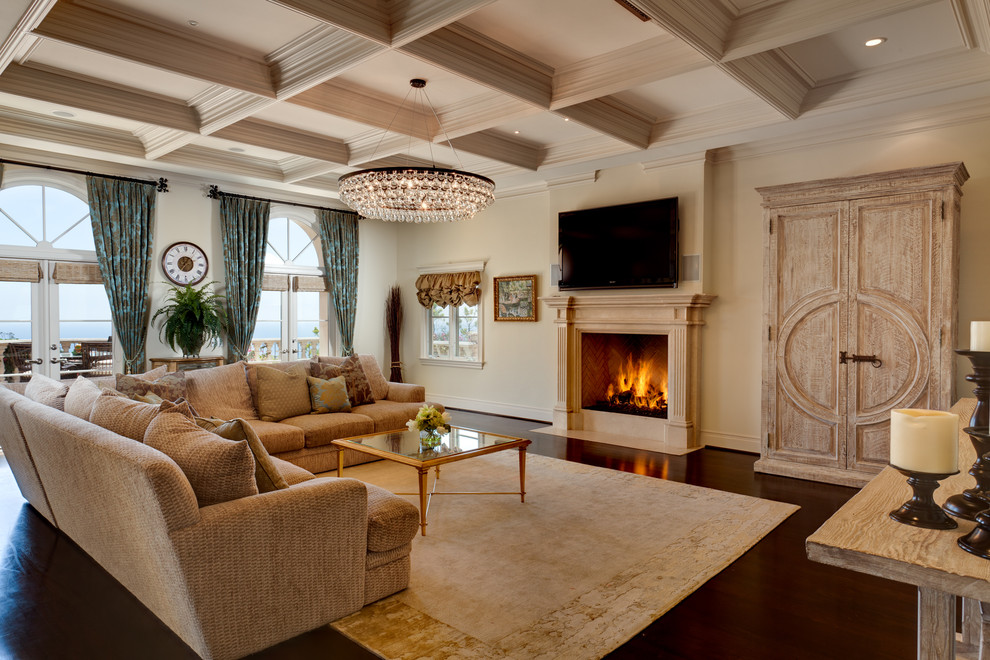 Стильный дизайн: гостиная комната в классическом стиле с бежевыми стенами, стандартным камином, телевизором на стене и красивыми шторами - последний тренд