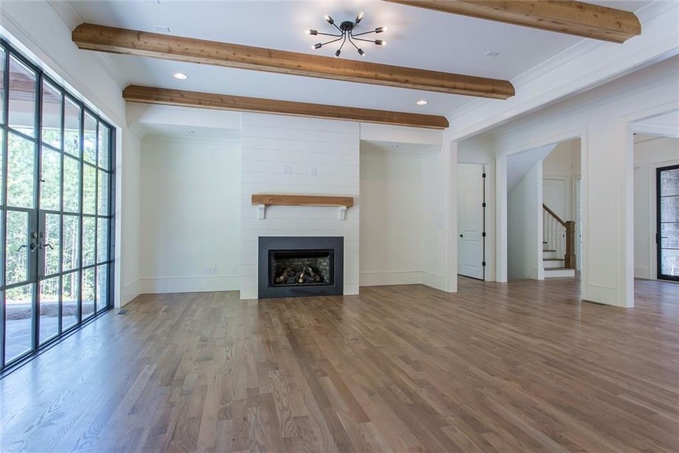 Family room - large transitional open concept light wood floor and gray floor family room idea in Atlanta with white walls, a standard fireplace, a stone fireplace and a wall-mounted tv
