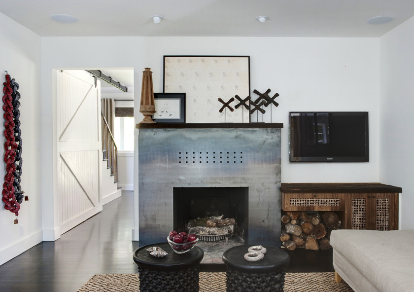 Example of a large trendy enclosed dark wood floor family room design in San Francisco with white walls, a standard fireplace, a metal fireplace and a wall-mounted tv