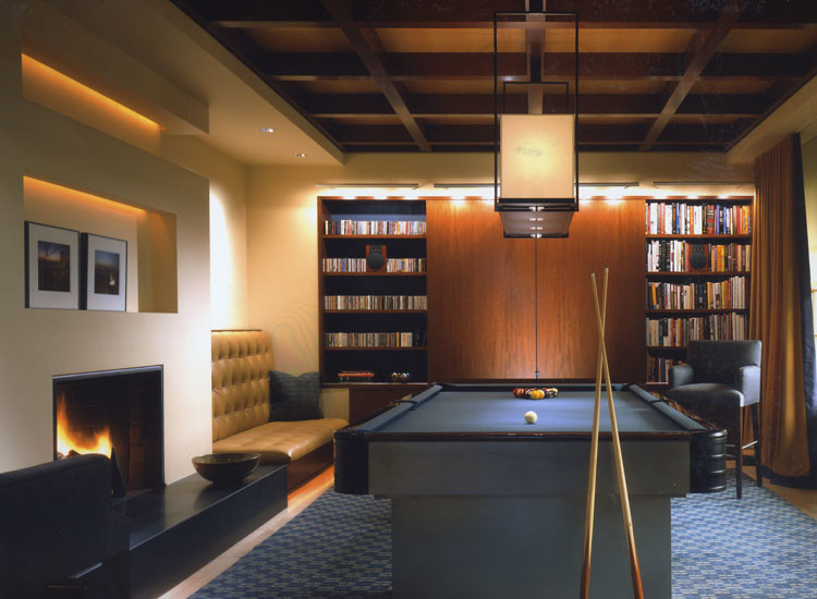 Design ideas for a large contemporary enclosed games room in New York with a game room, beige walls, carpet, a standard fireplace, a plastered fireplace surround, a concealed tv and blue floors.
