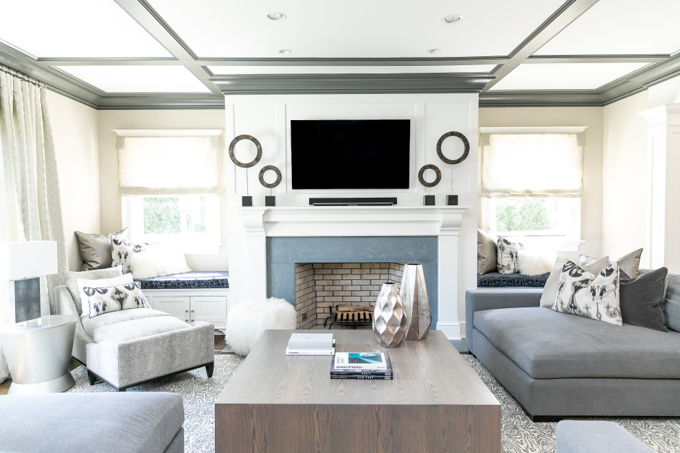 Transitional family room photo in New York with beige walls, a standard fireplace and a wall-mounted tv