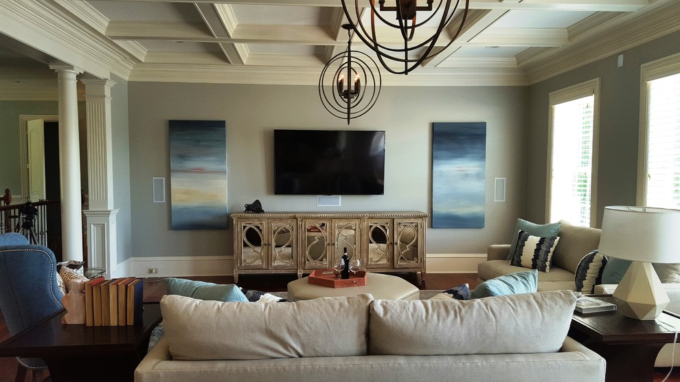 Идея дизайна: большая изолированная гостиная комната в стиле неоклассика (современная классика) с серыми стенами, темным паркетным полом, двусторонним камином, фасадом камина из камня, телевизором на стене и коричневым полом