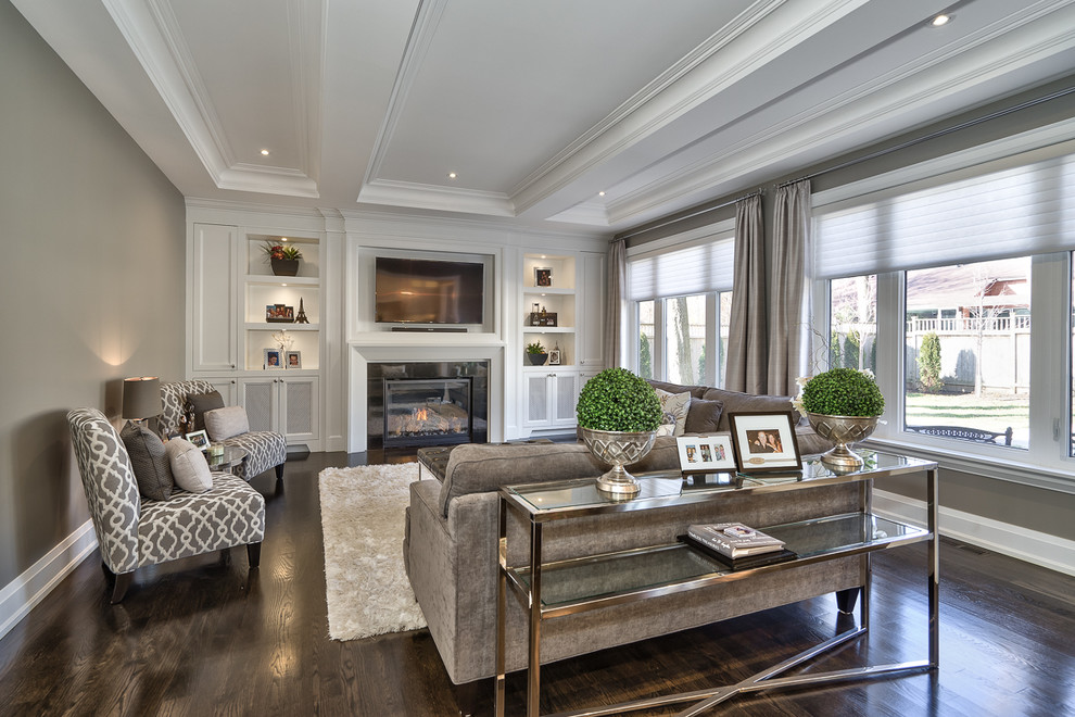 Family room - large contemporary enclosed dark wood floor family room idea in Toronto with gray walls, a standard fireplace, a plaster fireplace and a wall-mounted tv