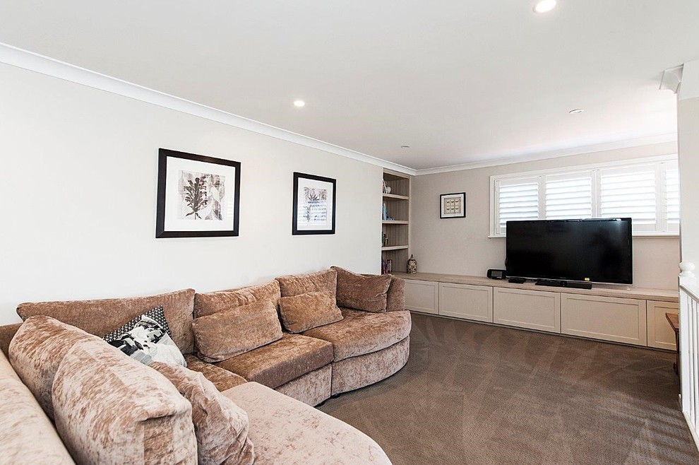 Small elegant loft-style carpeted family room photo in Perth with beige walls and a tv stand