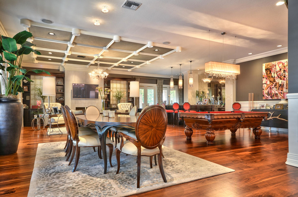 Inspiration for a large traditional open plan games room in Tampa with grey walls, medium hardwood flooring, a standard fireplace, a stone fireplace surround, a wall mounted tv and a game room.
