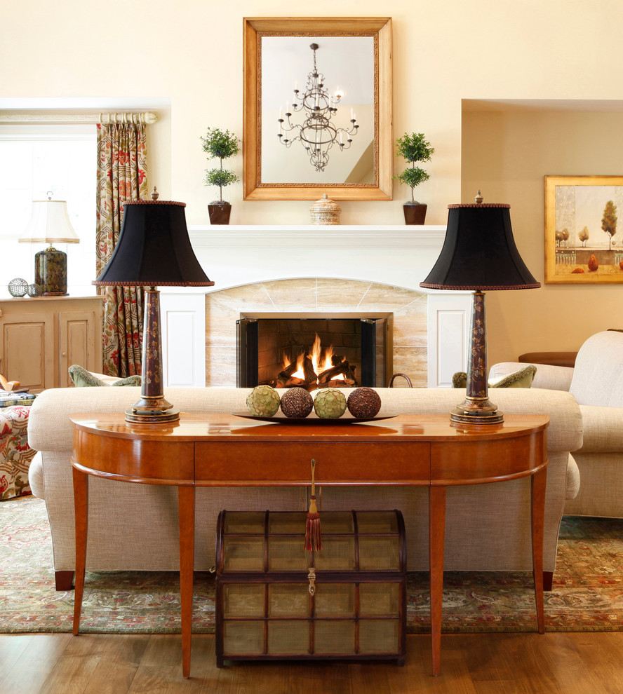 Inspiration for a timeless medium tone wood floor family room remodel in Philadelphia with beige walls, a standard fireplace and no tv