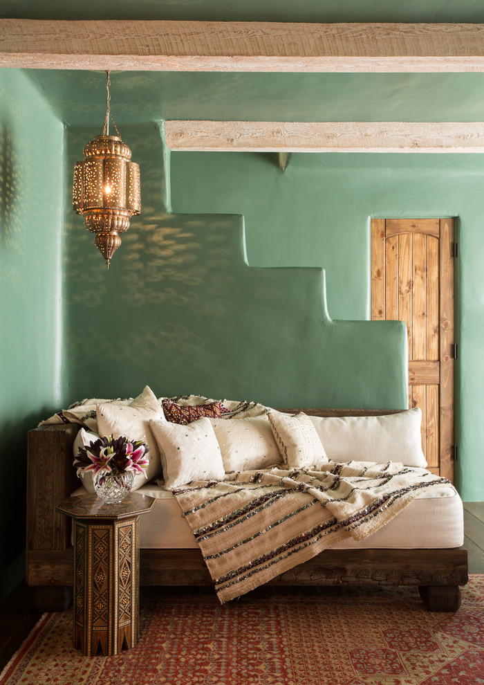 Family room - large southwestern enclosed dark wood floor family room idea in Albuquerque with green walls
