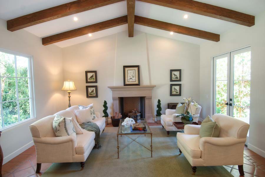 This is an example of a medium sized classic enclosed games room in Los Angeles with white walls, ceramic flooring, a standard fireplace, a stone fireplace surround and no tv.