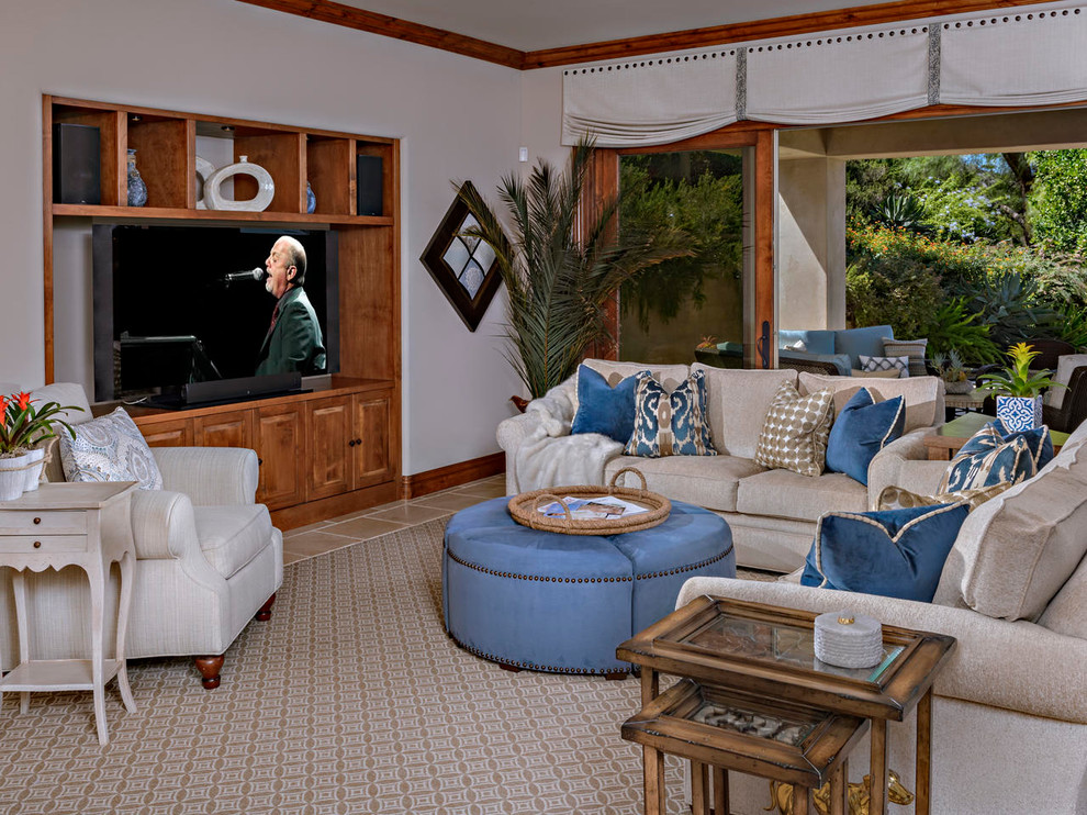 Modelo de sala de estar abierta mediterránea grande con paredes beige, moqueta, pared multimedia y suelo marrón