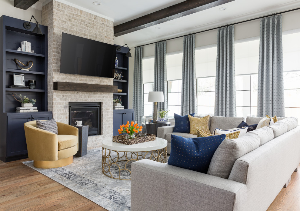 Inspiration for a transitional medium tone wood floor, brown floor and exposed beam family room remodel in Houston with white walls, a standard fireplace and a stone fireplace
