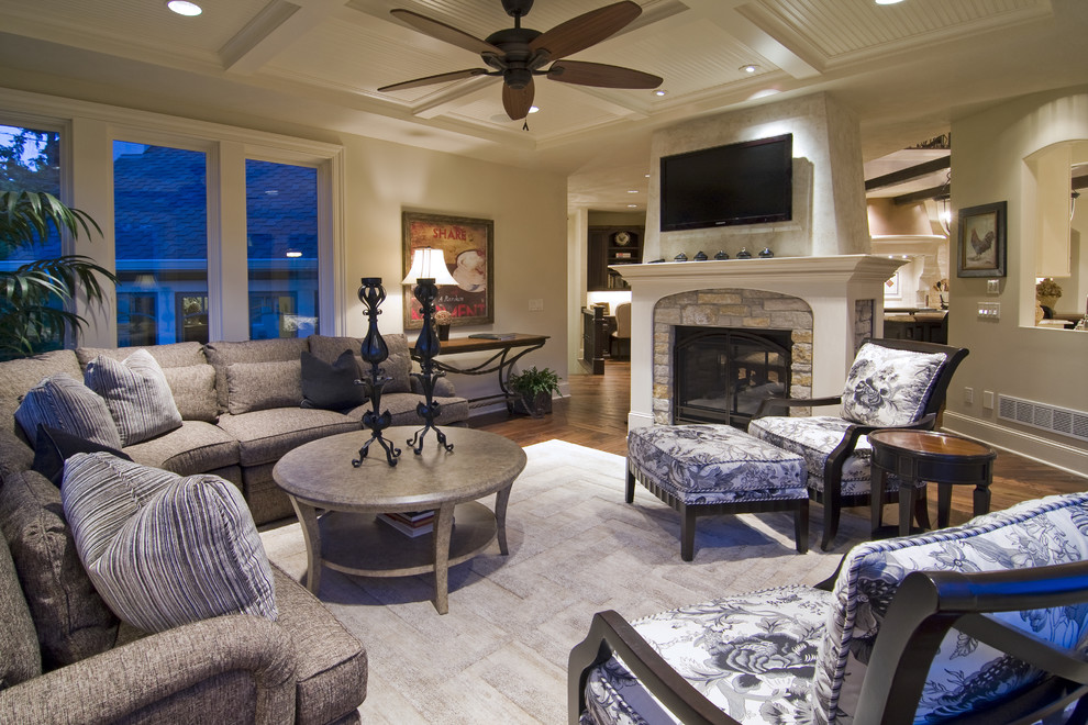 Elegant family room photo in Minneapolis with a stone fireplace