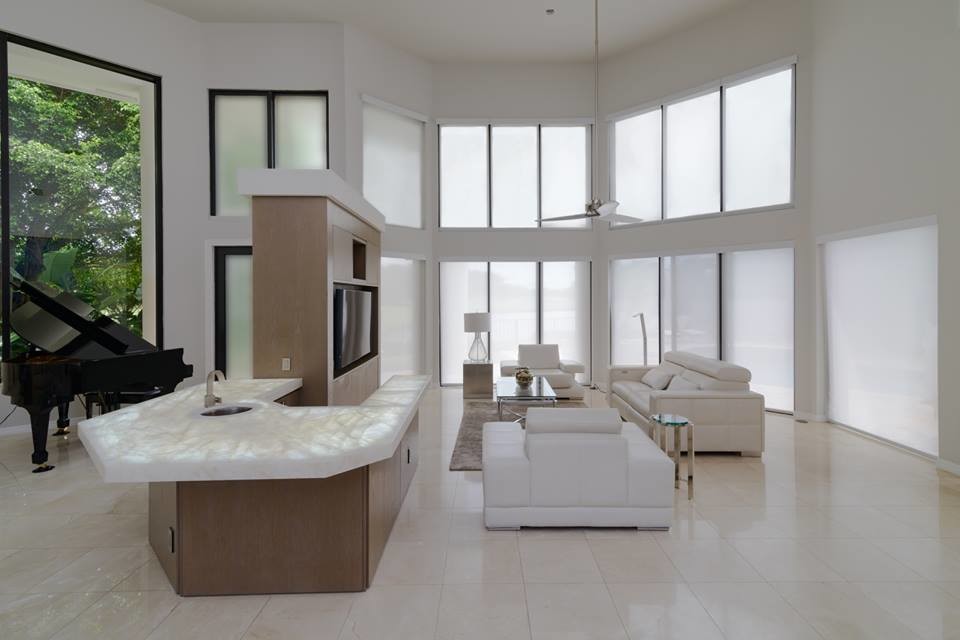 This is an example of a medium sized contemporary open plan games room in Miami with a music area, white walls, porcelain flooring, a built-in media unit and white floors.