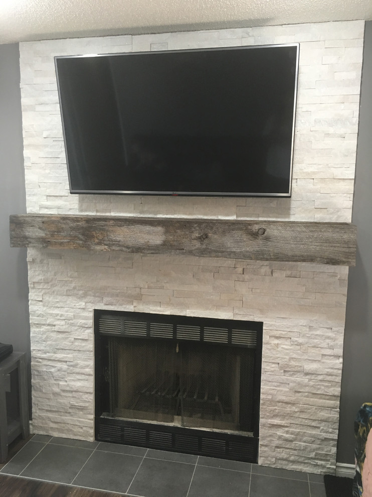 Inspiration for a rustic games room in Calgary with a standard fireplace and a stone fireplace surround.