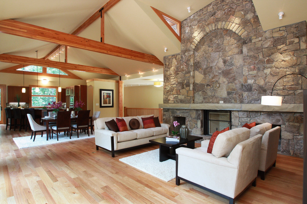 Photo of a rustic games room in Charlotte with a stone fireplace surround and beige floors.