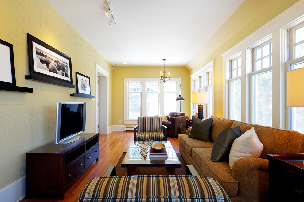 Inspiration for a timeless family room remodel in Calgary with yellow walls