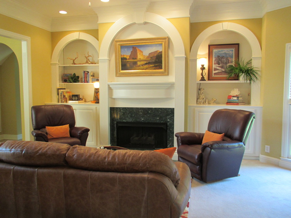 Mid-sized elegant enclosed carpeted family room photo in Nashville with yellow walls, a standard fireplace, a wood fireplace surround and no tv