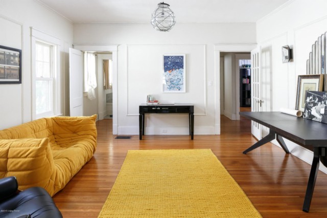 Modelo de sala de estar abierta bohemia de tamaño medio con paredes blancas y suelo de madera en tonos medios