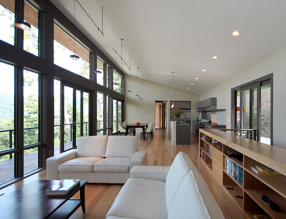 Ejemplo de sala de estar abierta contemporánea con paredes beige y suelo de madera en tonos medios