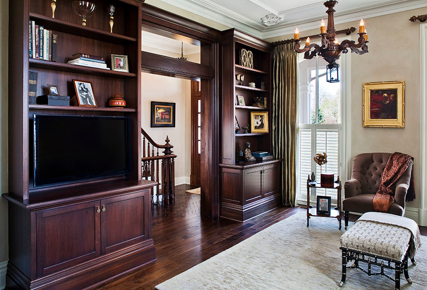 This is an example of a medium sized victorian enclosed games room in Minneapolis with beige walls, dark hardwood flooring, a freestanding tv and brown floors.